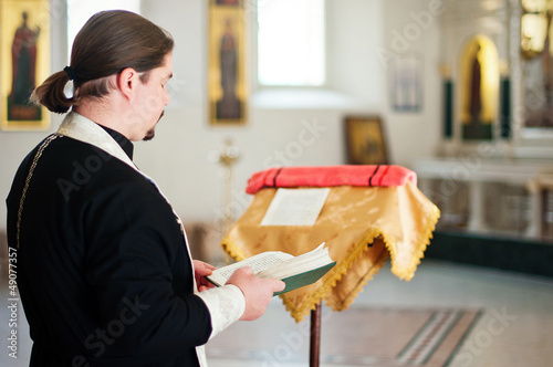 Photo: A priest in the church A priest in the church