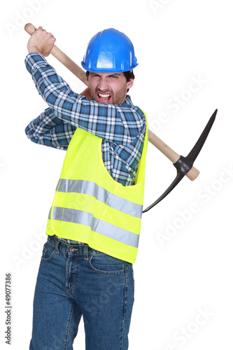 Photo: Aggressive labourer holding a pickaxe Aggressive labourer holding a pickaxe