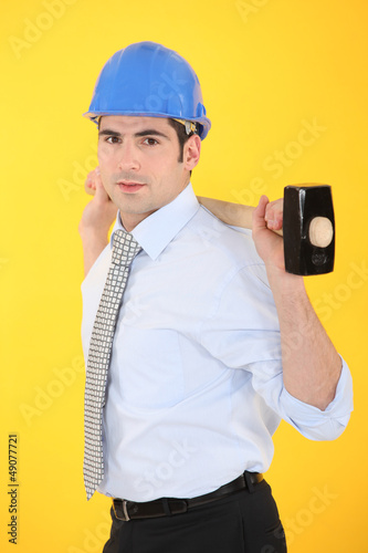 Photo: architect holding hammer architect holding hammer