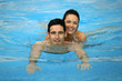 Couple swimming in pool