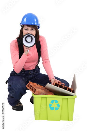 Photo: A female construction worker promoting recycling. A female construction worker promoting recycling.