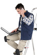 Photo: Tiler with a laptop Tiler with a laptop