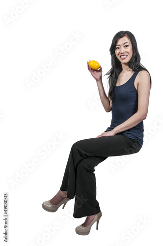 Photo: Woman Sitting with a lemon Woman Sitting with a lemon