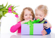 2 kids with gift and flowers
