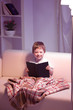 boy read book indoors