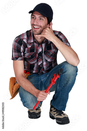 Photo: workman doing sign to make a phone call workman doing sign to make a phone call