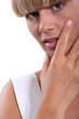 Young woman with her hand to her face