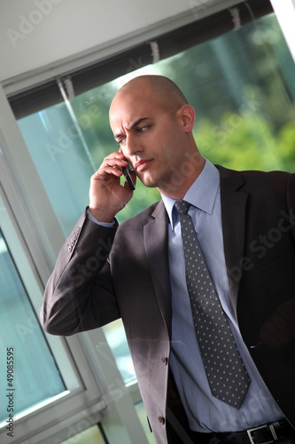 Photo: Concerned businessman making important call Concerned businessman making important call