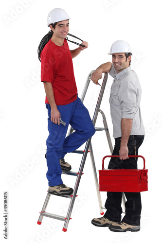 Photo: Electrician and young apprentice Electrician and young apprentice