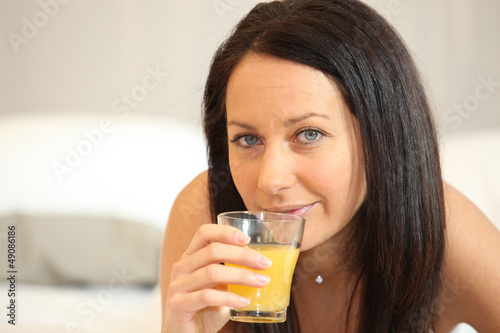 Photo: Brunette woman with orange juice Brunette woman with orange juice