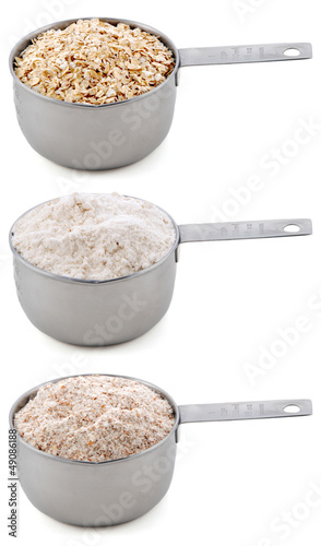 Photo: Everyday staple ingredients - rolled oats and flours - in cup me Everyday staple ingredients - rolled oats and flours - in cup me