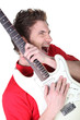 Man enthusiastically playing his guitar