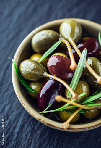 Photo: Marinated olives and caper berries with rosemary Marinated olives and caper berries with rosemary