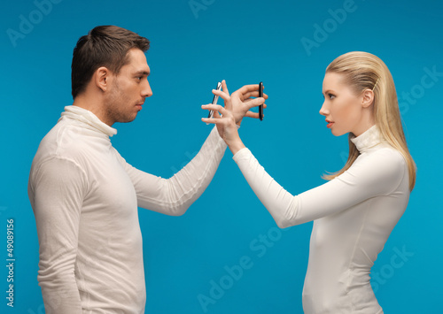Photo: man and woman with modern gadgets man and woman with modern gadgets
