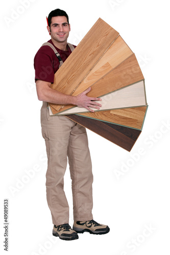 Photo: Carpenter with an assortment of flooring Carpenter with an assortment of flooring