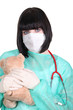 Female doctor holding teddy bear