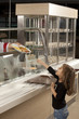 	little girl in cafeteria line trying to take her healthy meal