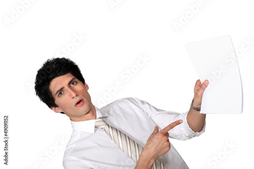 Photo: Surprised man showing a document Surprised man showing a document