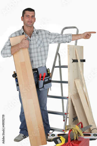 Photo: Carpenter pointing at empty copy space Carpenter pointing at empty copy space