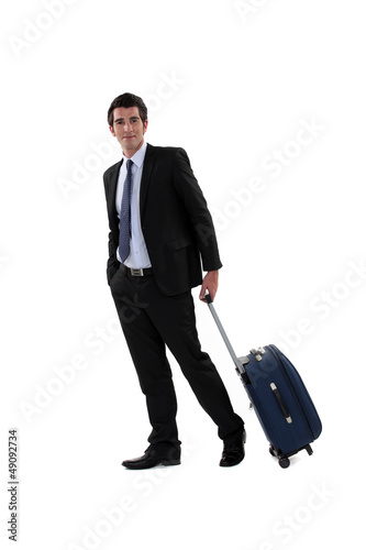 Photo: A businessman with his luggage. A businessman with his luggage.