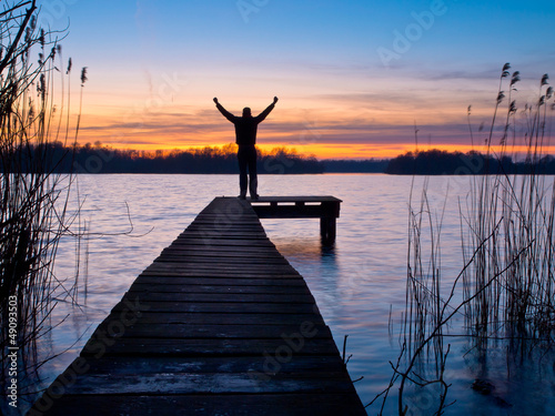Photo: Man is raising his arms Man is raising his arms