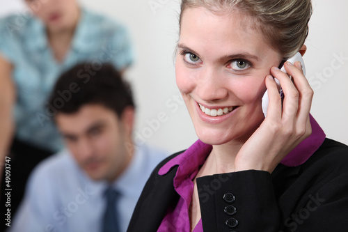 Photo: Female office worker on the telephone Female office worker on the telephone