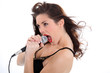 Woman singing loudly into a microphone