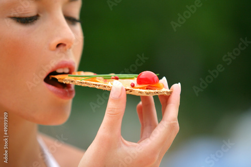 Photo: Woman eating healthy cracker snack Woman eating healthy cracker snack