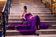 woman in a long dress lying on the stairs