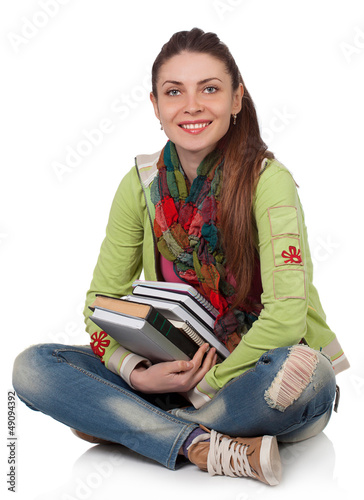 Photo: Beautiful student girl sitting with books Beautiful student girl sitting with books
