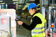Warehouseman in protective vest using a scanner
