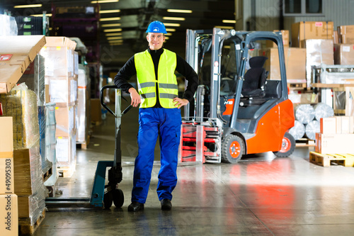 Photo: Warehouseman in protective vest using a scanner Warehouseman in protective vest using a scanner