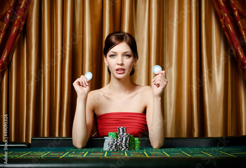 Photo: Woman with chips sitting at the roulette table Woman with chips sitting at the roulette table