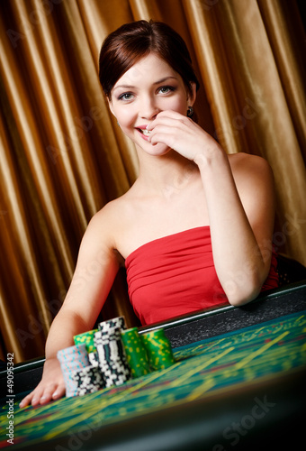 Photo: Smiley woman with piles of chips at the roulette table Smiley woman with piles of chips at the roulette table