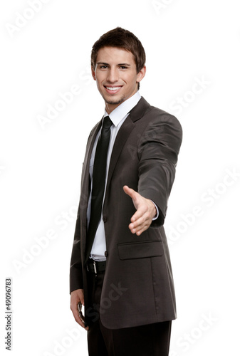 Photo: Friendly businessman giving hand for a handshake Friendly businessman giving hand for a handshake