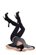 Woman lies on her back with  feet raised