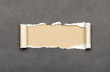 Torn grey paper with beige copyspace for your message