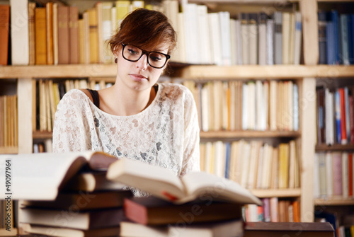 Photo: nachdenkliche Frau im Bücherwahn nachdenkliche Frau im Bücherwahn