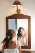 Photo: Teen pretty girl happy with their appearance in the mirror Teen pretty girl happy with their appearance in the mirror
