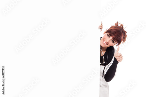 Photo: Smiling brunette female doctor with message board Smiling brunette female doctor with message board