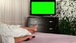 Video: Woman watches television with green screen Woman watches television with green screen