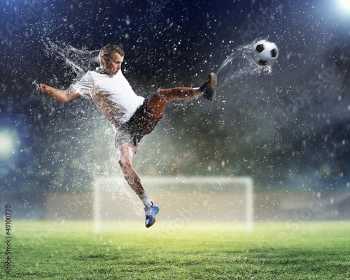 Photo: football player striking the ball football player striking the ball