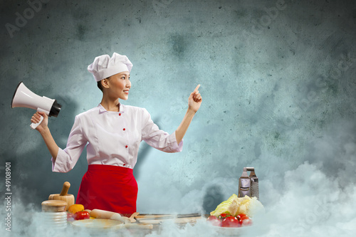 Photo: Asian female cook holding megaphone Asian female cook holding megaphone