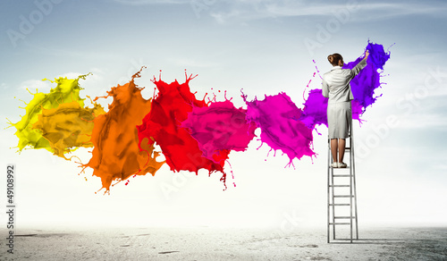 Photo: Young woman drawing splashes Young woman drawing splashes