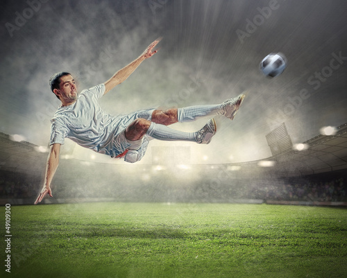 Photo: football player striking the ball football player striking the ball