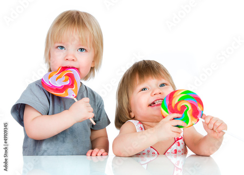 Photo: Babies eating a sticky lollipop Babies eating a sticky lollipop