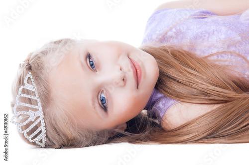 Photo: Beautiful little girl lay with tiara on head Beautiful little girl lay with tiara on head