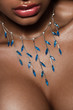 female lips with blue jewelry