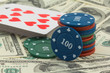 Фото: playing chips and cards on a dollars banknotes playing chips and cards on a dollars banknotes