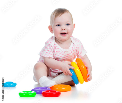 Photo: cheerful child playing with colorful toy isolated on white cheerful child playing with colorful toy isolated on white